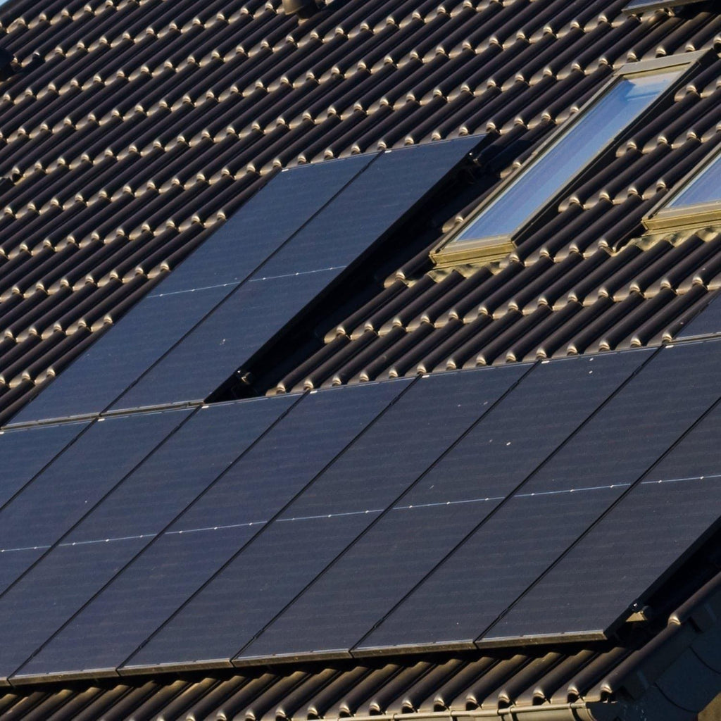 Solar panels on a roof with a clear sky background