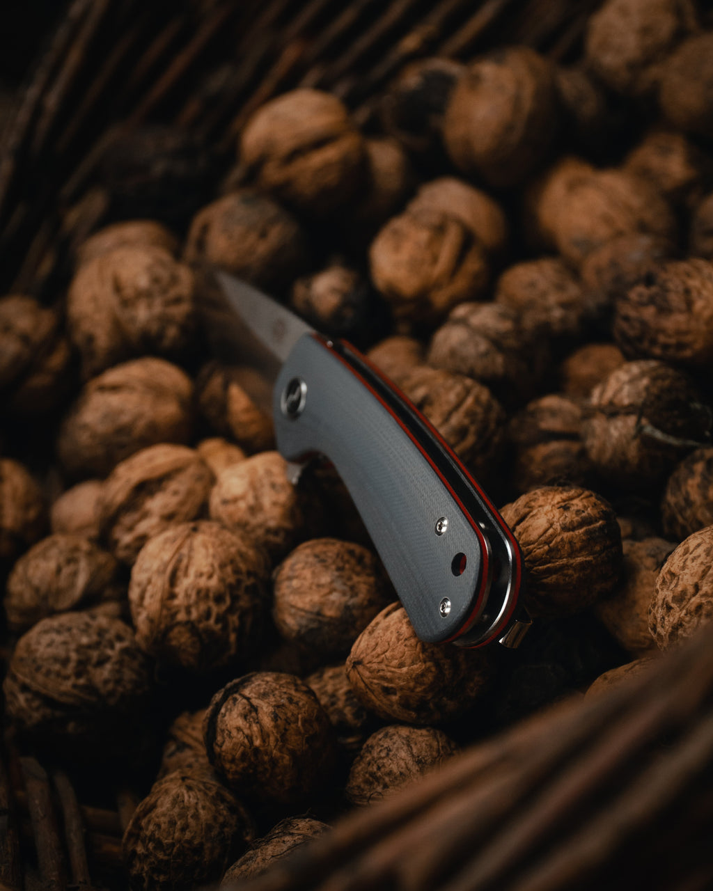 Pocket knife on a pile of walnuts