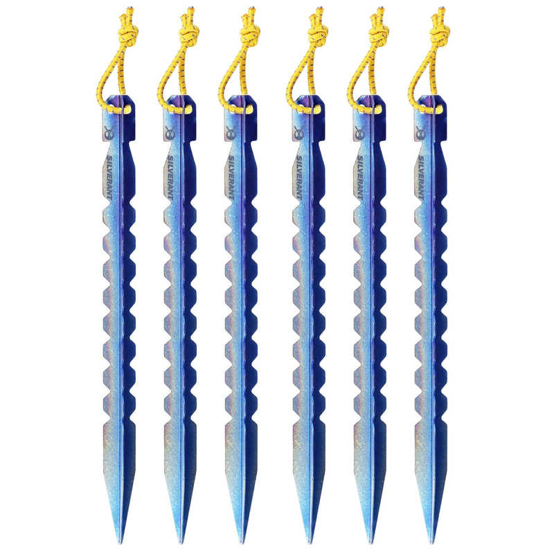 Set of six blue tent stakes with yellow strings on a white background