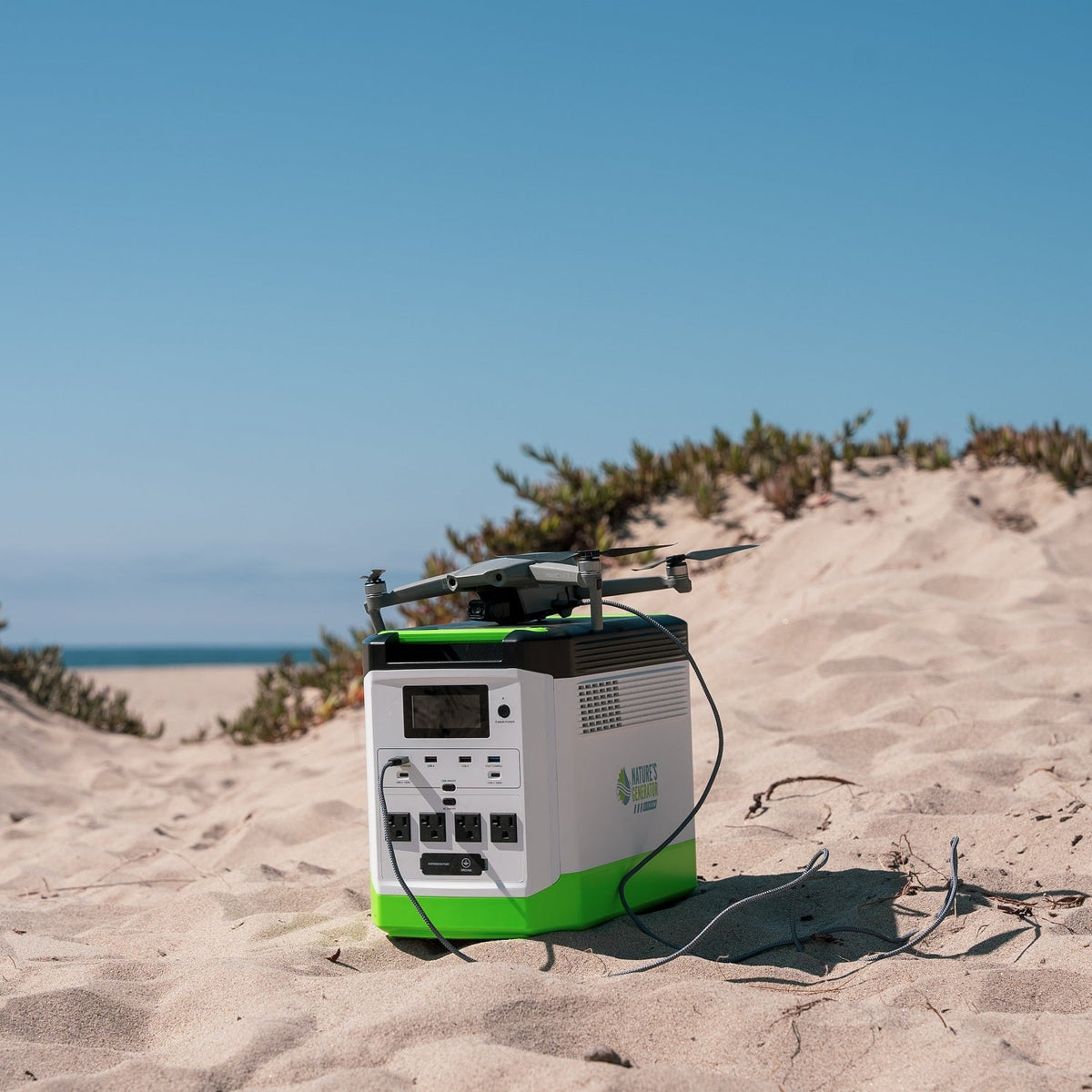 Portable power station with a drone on a sandy beach