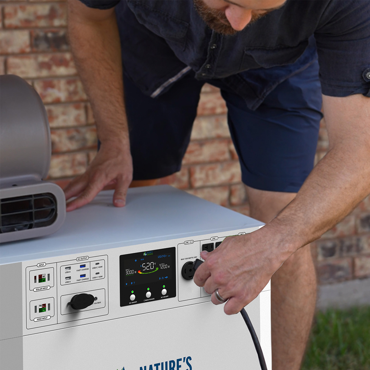 Person interacting with a portable power station outdoors