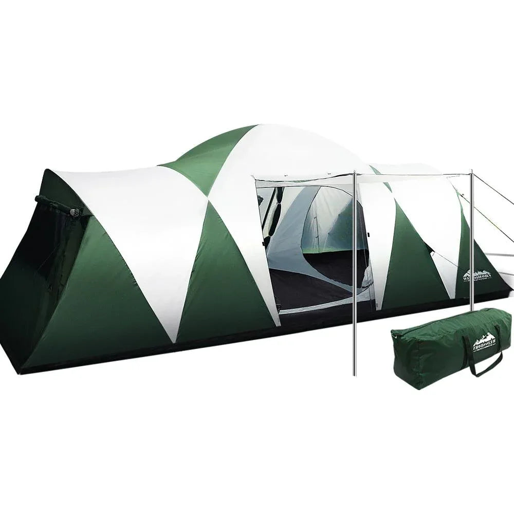 A green and white dome-style camping tent with an attached vestibule and silver support poles, shown on a plain white background with its carrying bag beside it.