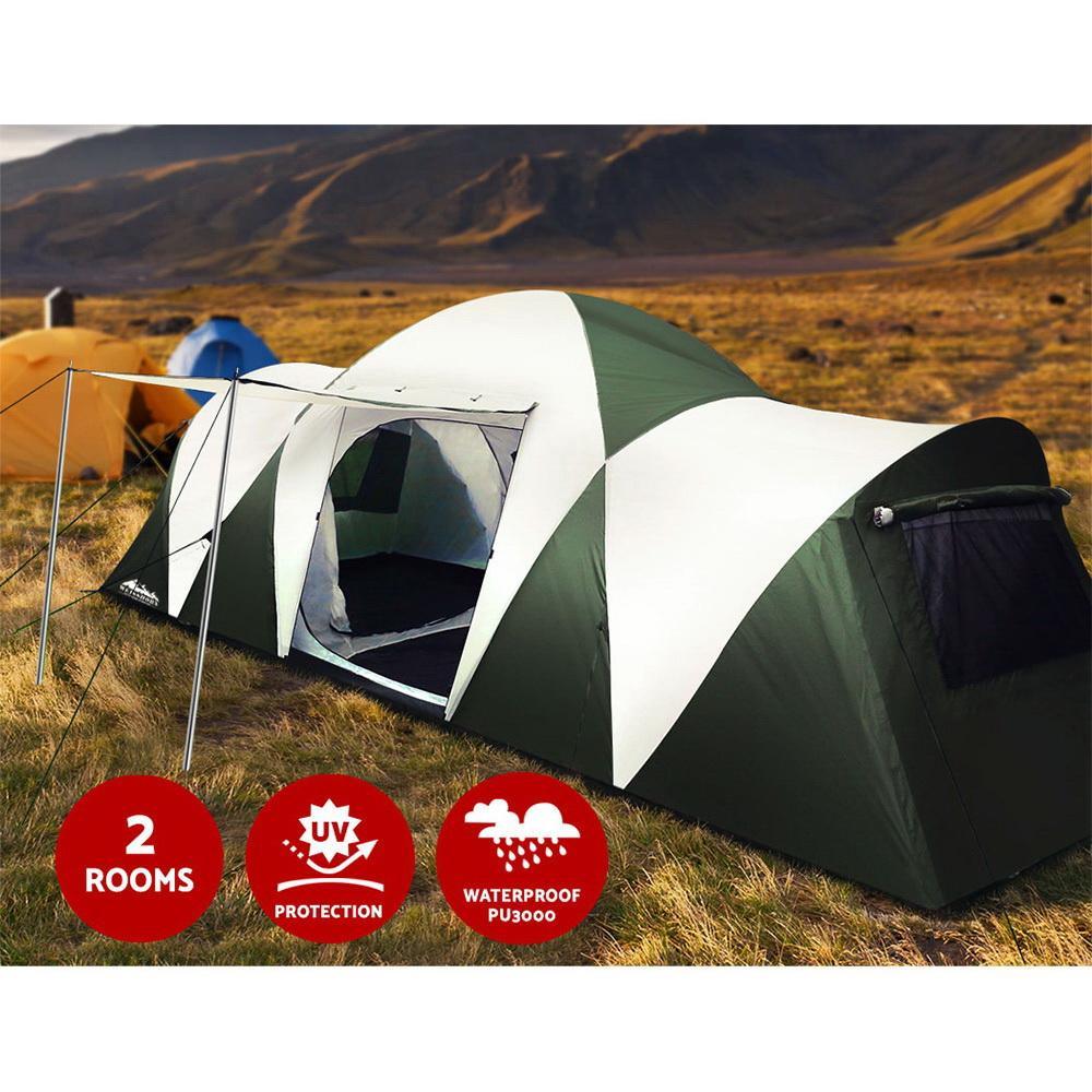 Green and white tent in a field with mountainous background, featuring UV protection and waterproof labels.