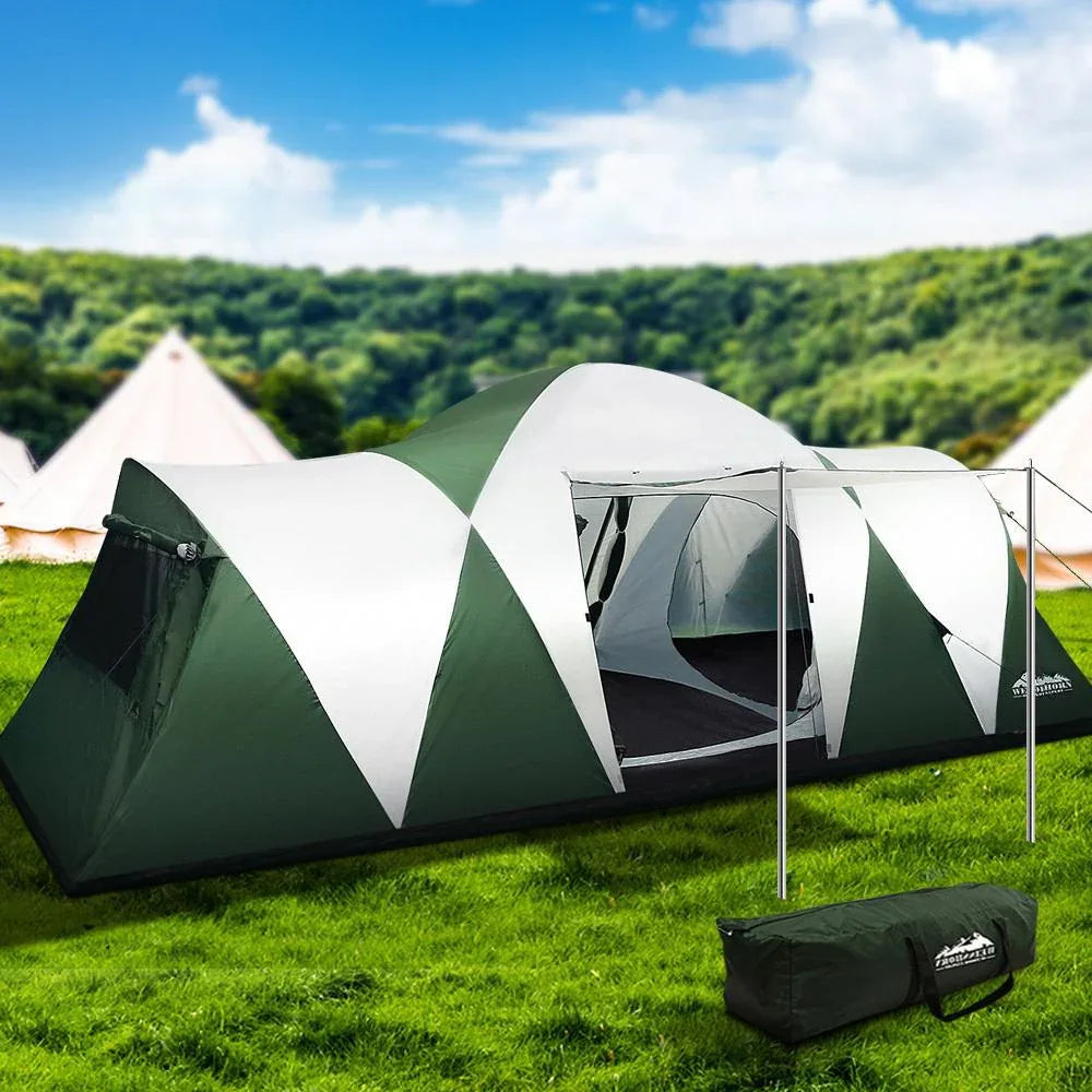 Green and white tent with a carrying bag on grass under a blue sky