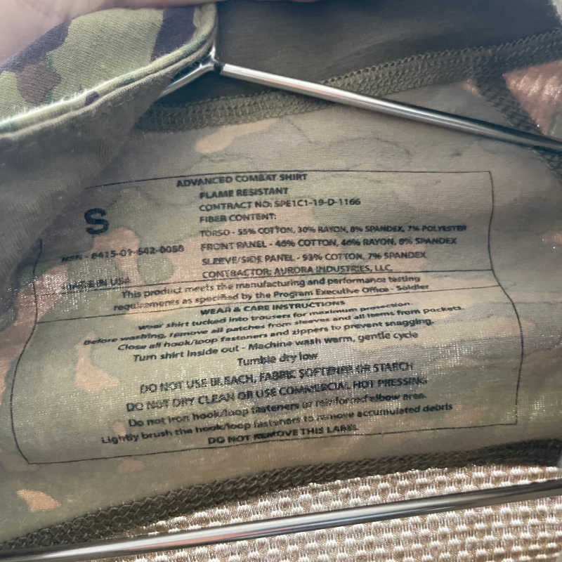 Camouflage shirt label with text on a camouflage background