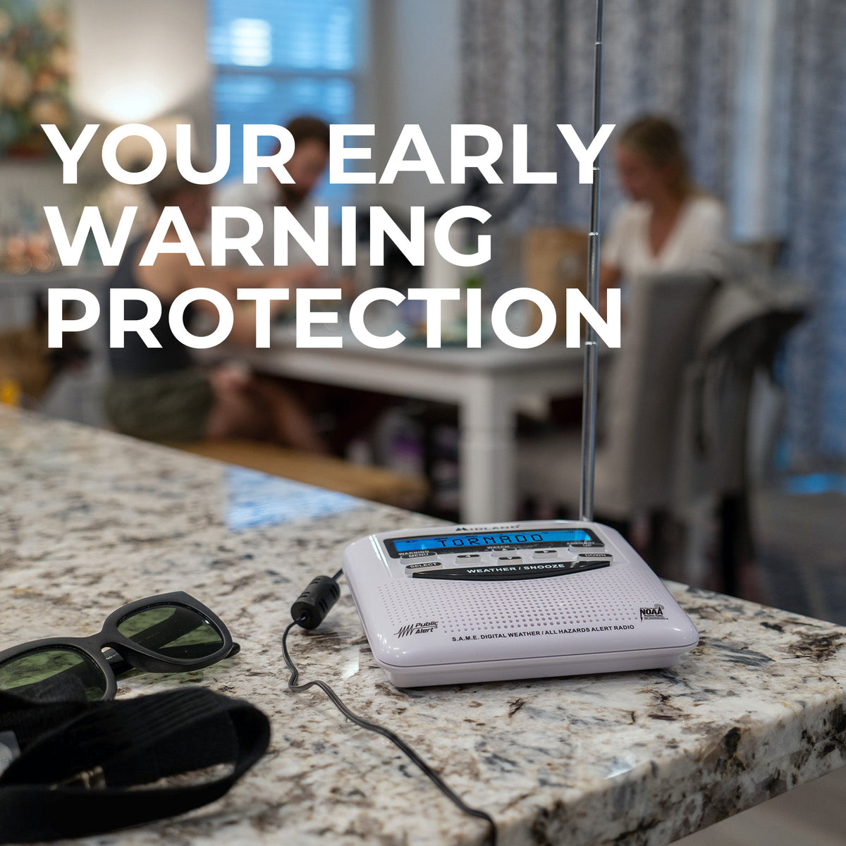 Radio on a kitchen counter with text 'Your Early Warning Protection' and people in the background.
