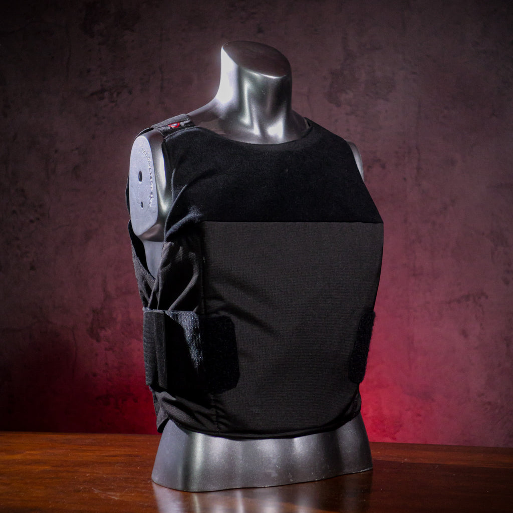 Black bulletproof vest on a mannequin against a dark background