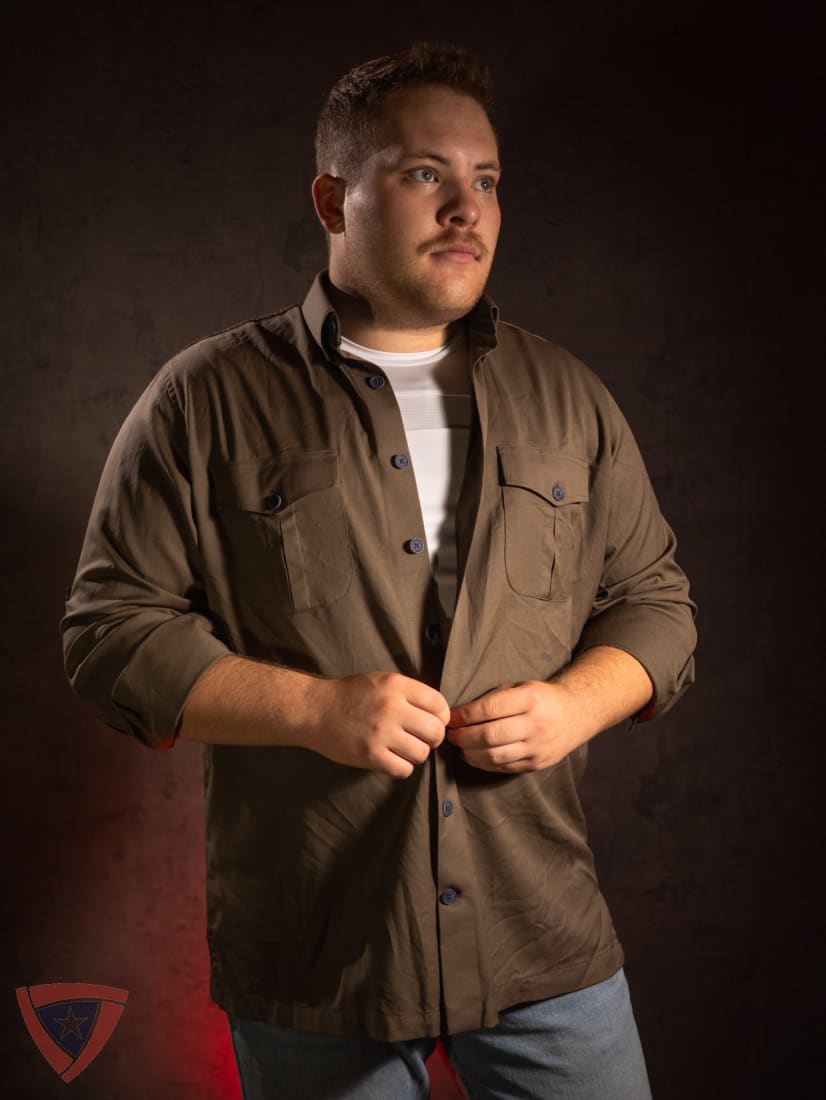 Man wearing a brown jacket against a dark background