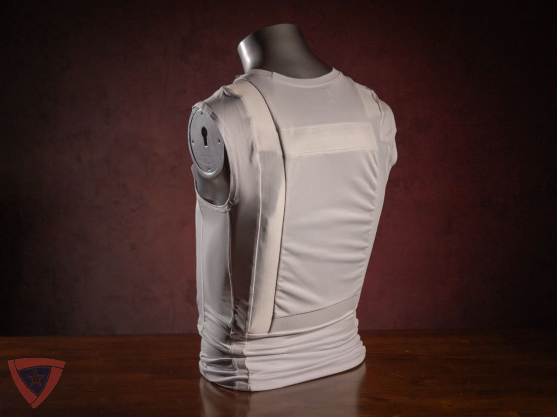 Mannequin wearing a beige tactical vest against a dark background