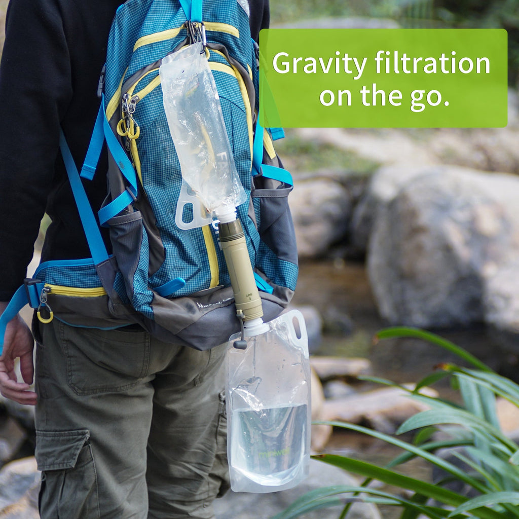 Person with a backpack containing a water filtration system near a natural setting.