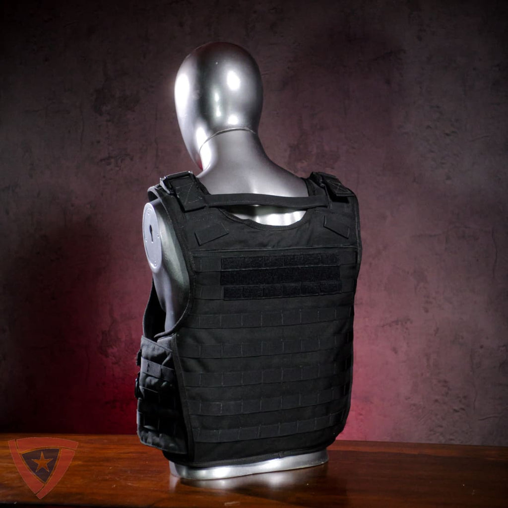 Black tactical vest on a mannequin against a dark background