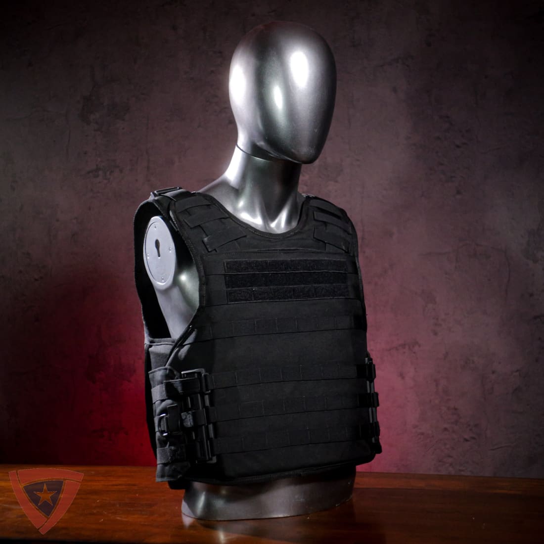 Black tactical vest on a mannequin against a dark background