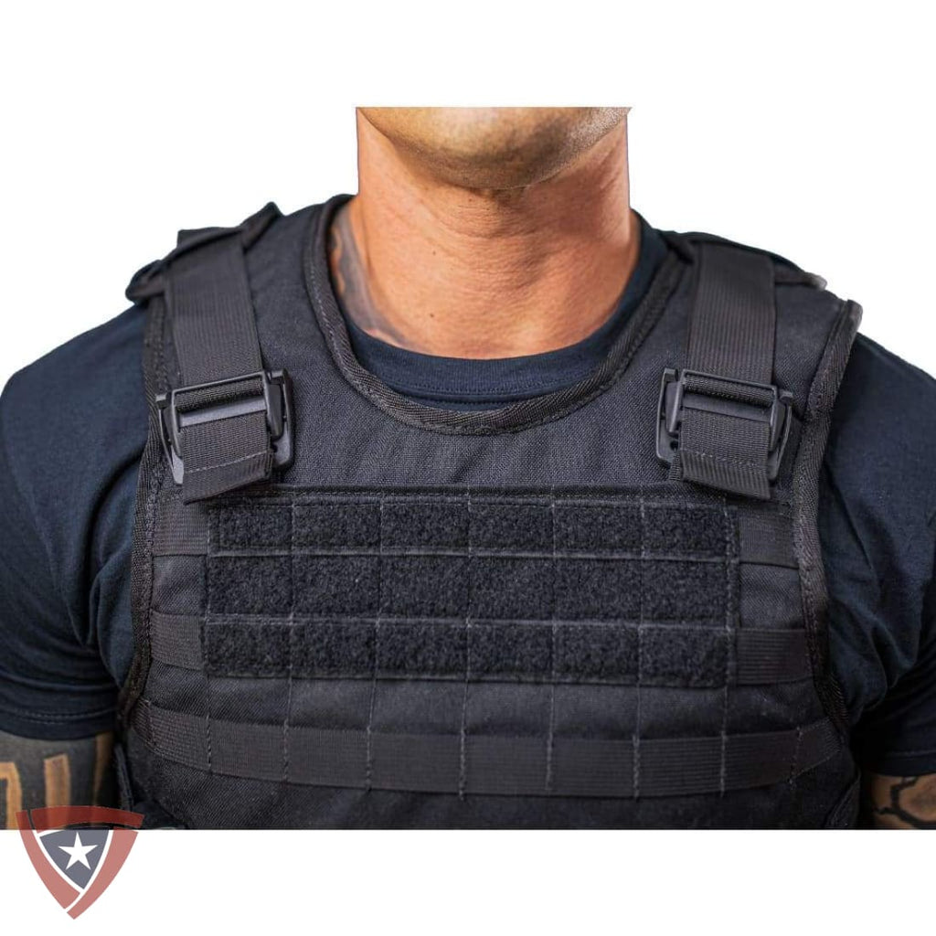 Person wearing a black tactical vest on a white background