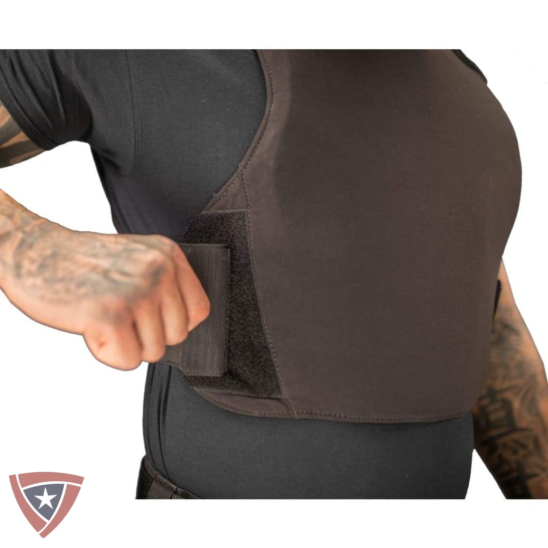 Person wearing a brown back brace with a visible brand logo at the bottom left corner.
