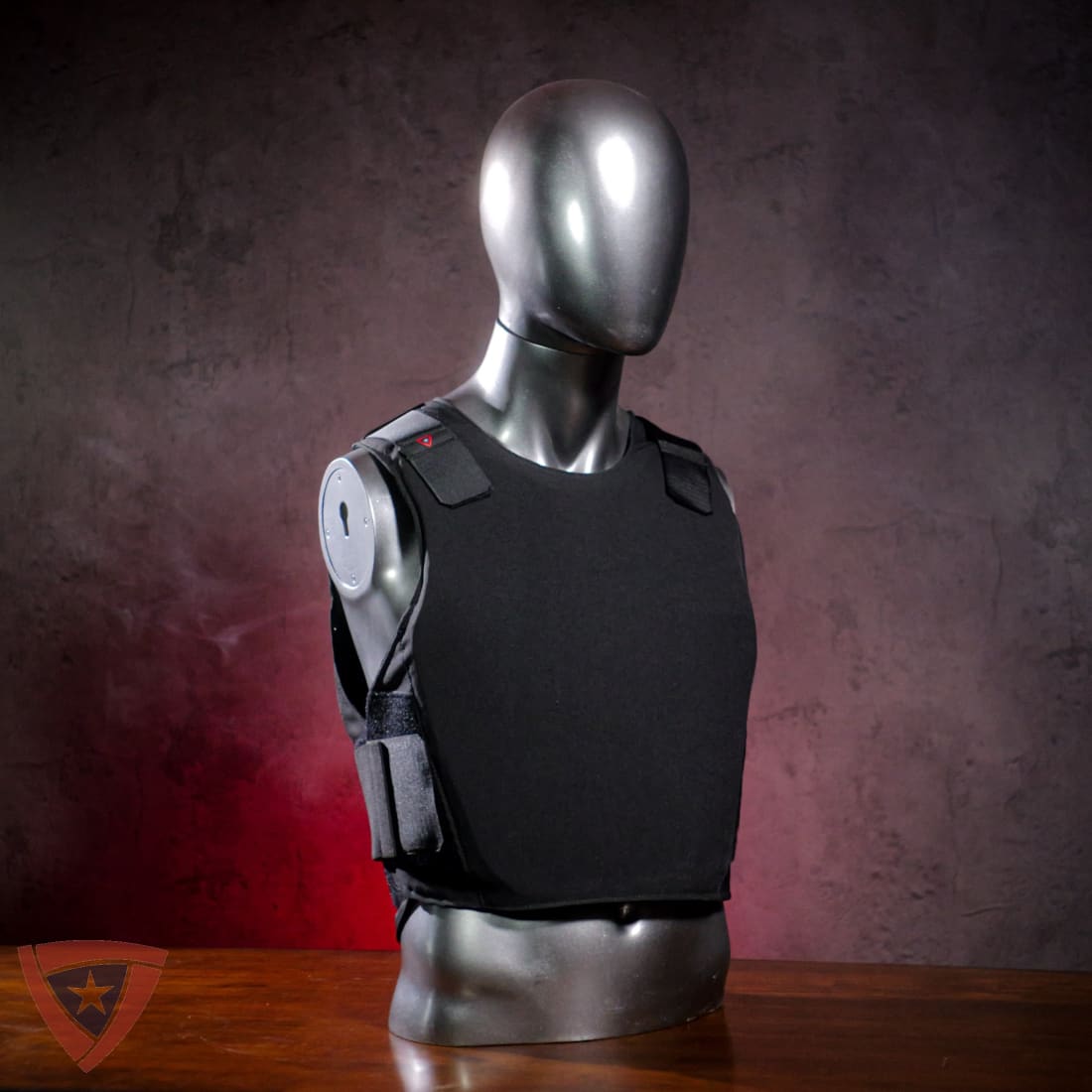 Black tactical vest on a mannequin against a dark background