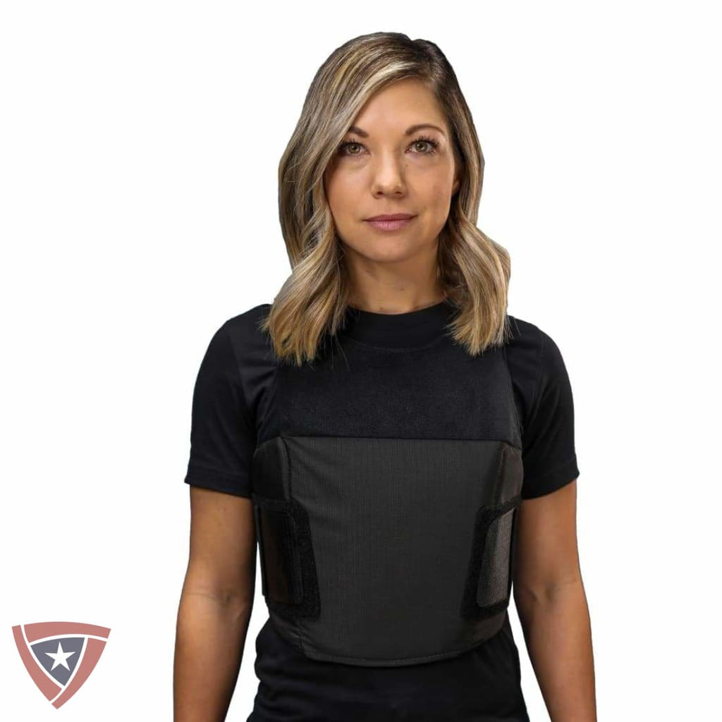 Woman wearing a black tactical vest on a white background