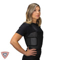 Woman wearing a black tactical vest on a white background