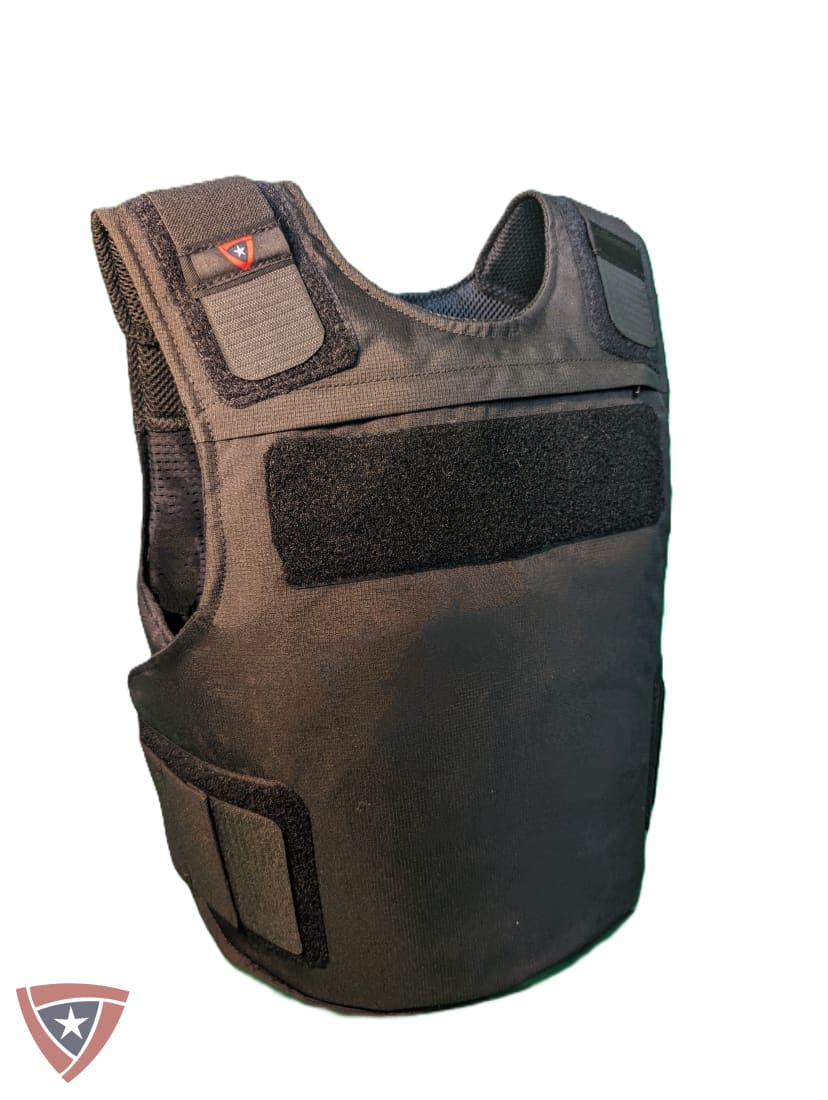 A black tactical vest or plate carrier shown alone on a plain white background, with hook-and-loop panels and mesh side openings.