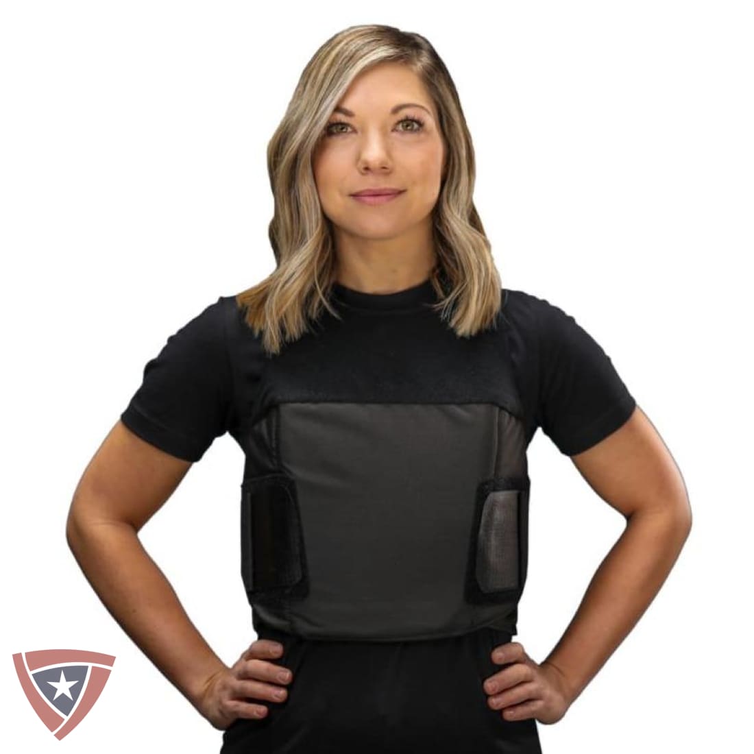 A woman modeling a black short-sleeve compression vest with a dark gray front panel and side pockets, shown against a plain white background.