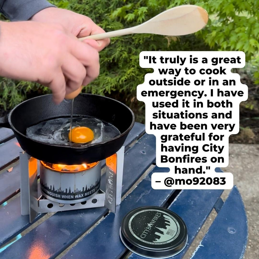 Person cooking an egg on a portable stove with a City Bonfires product in the background.